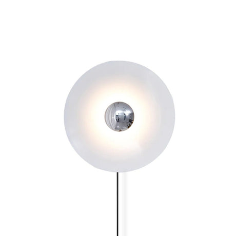 The white disc with a chrome center and its cord on a white background