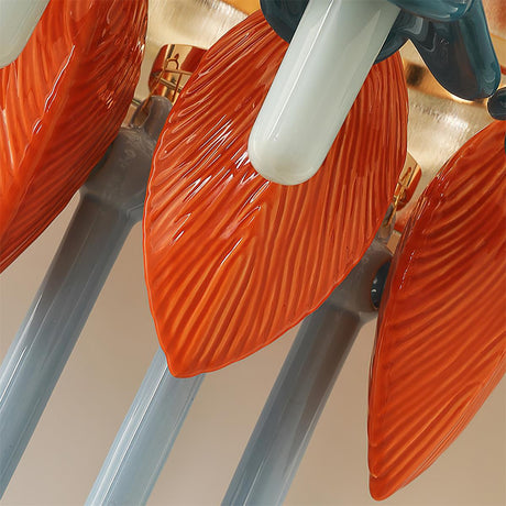 Close view of glossy orange ceramic petals and pale blue rods