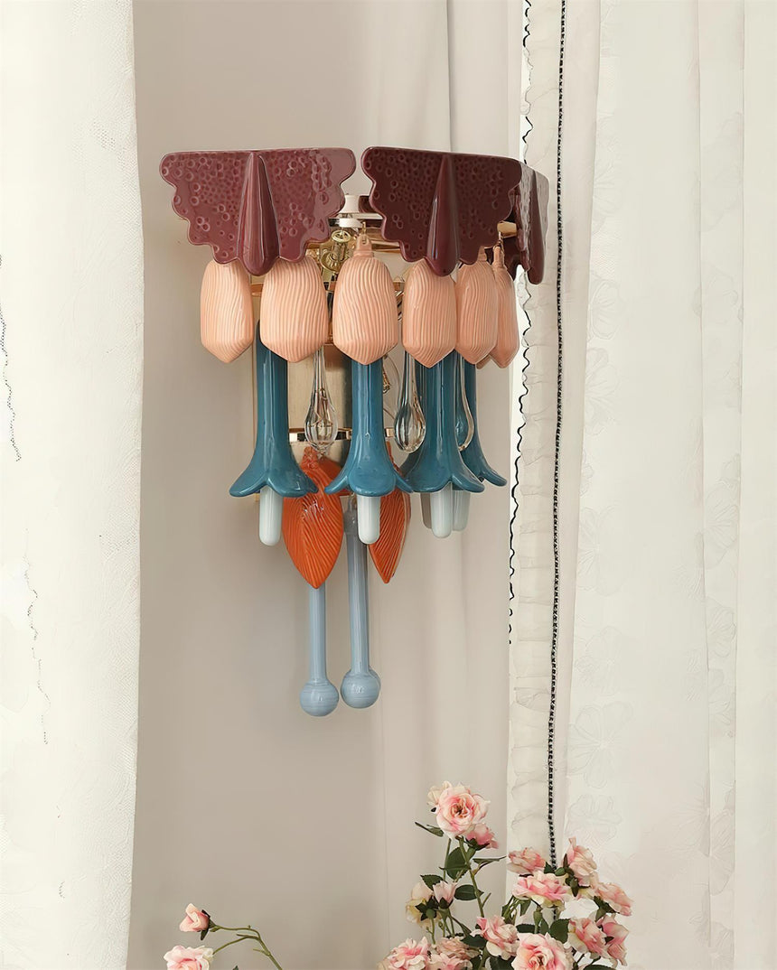 The sconce on a pale wall beside a window with sheer curtains