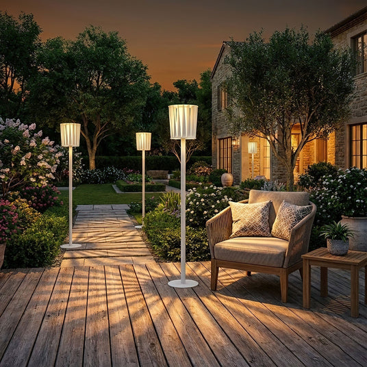 Two lit on a timber deck around a seating group at dusk