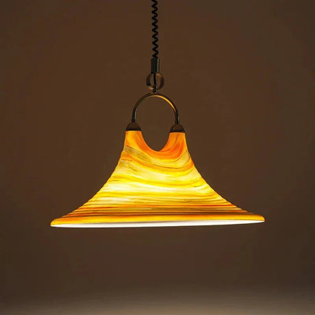 The striped glass cone lit against a dark background showing the stripes