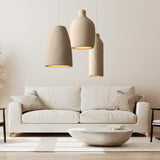 Three tapered resin shades hung above a cream sofa