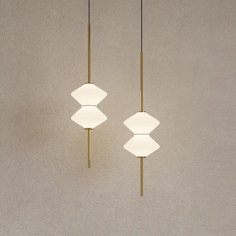 Two white double cone shades on black rods lit against a pale wall
