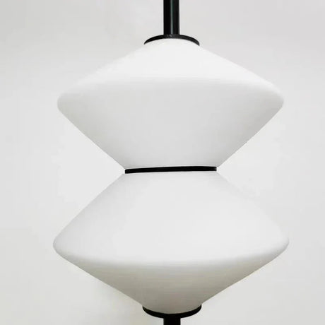 Close view of the two white cones joined rim to rim at a black collar