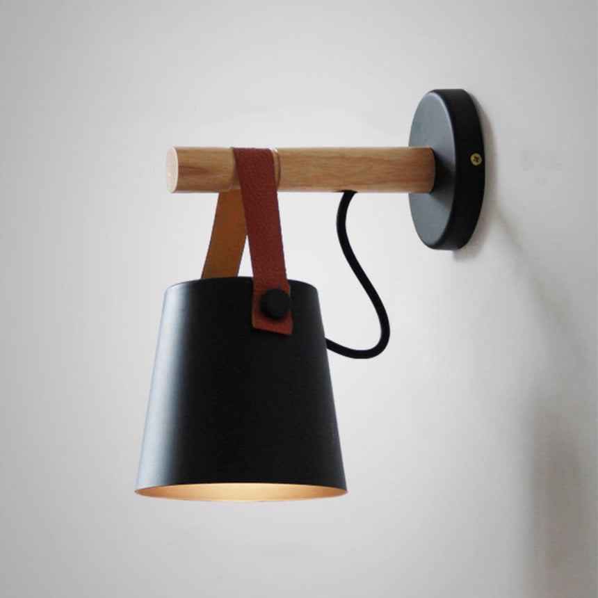 The black cone hanging from the wood bar, seen against a plain ground