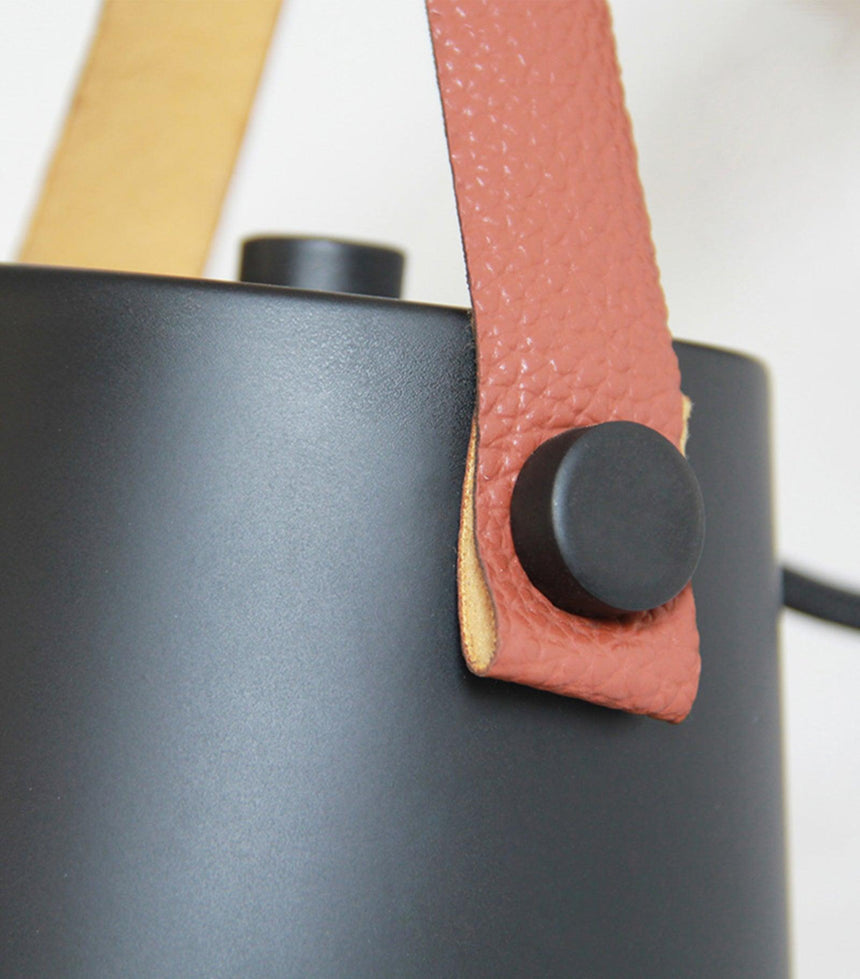 Close view of the stud that holds the leather strap against the shade