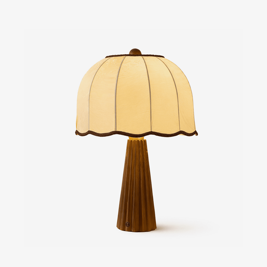 Table lamp with a scalloped cream shade on a fluted tapered walnut column