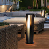 The bollard lit on a deck beside an outdoor sofa with pale cushions
