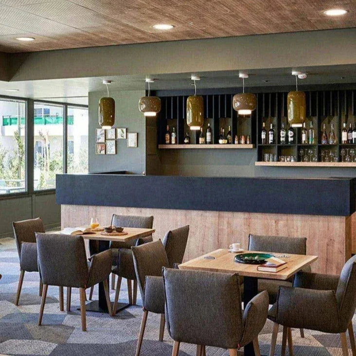Glass shades lit over tables in a bar interior