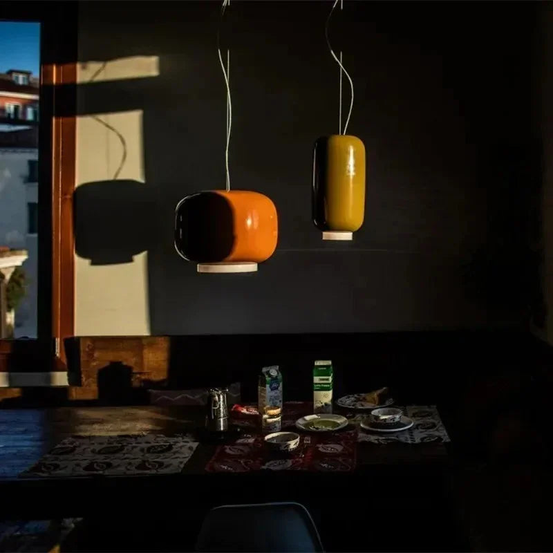 Two glass shades lit in a dark restaurant interior