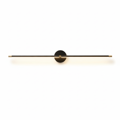 The black rod lit, the diffuser bright along its underside on a pale wall