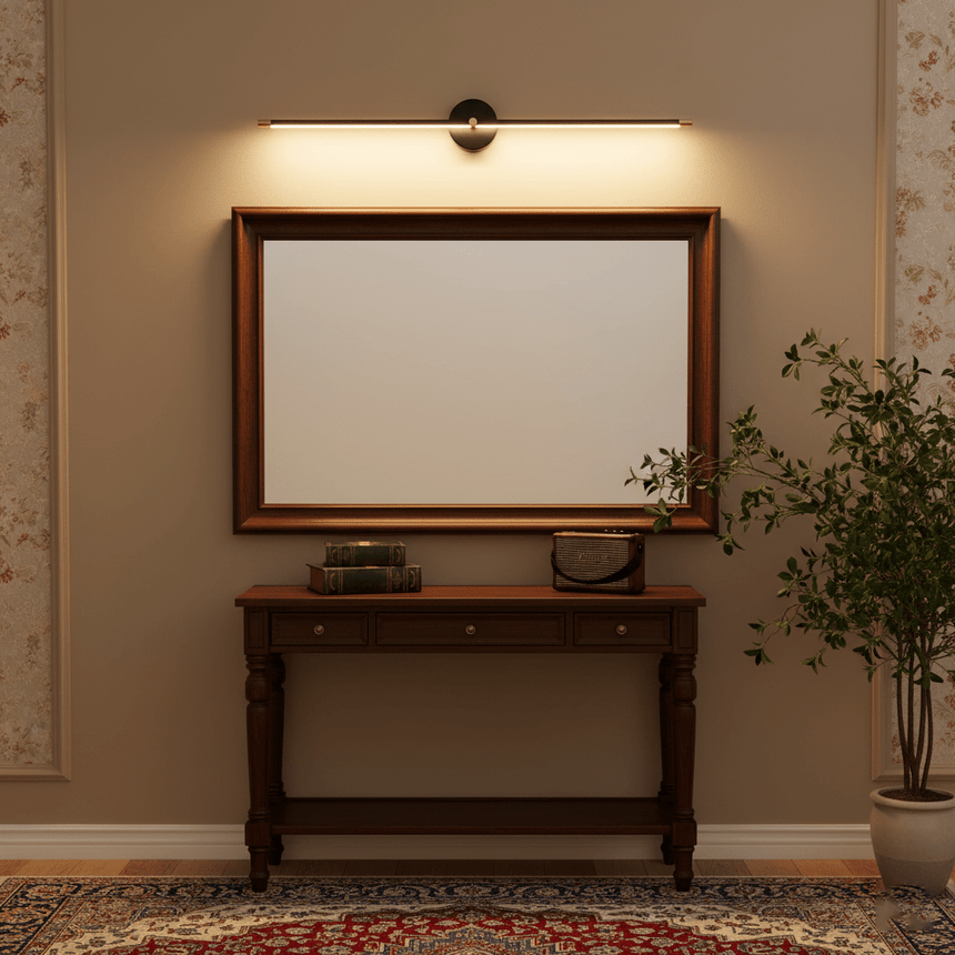 Gold rod lit above a framed mirror over a dark console table and a rug