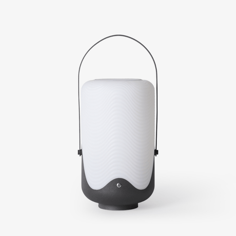 White lantern with a rounded shade and a black arch handle over the top