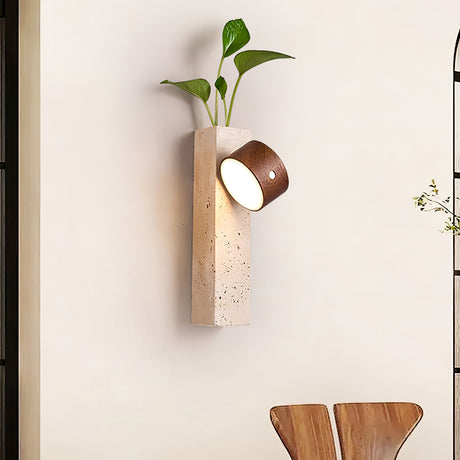 Wall sconce lit above a dining chair, the head turned toward the table