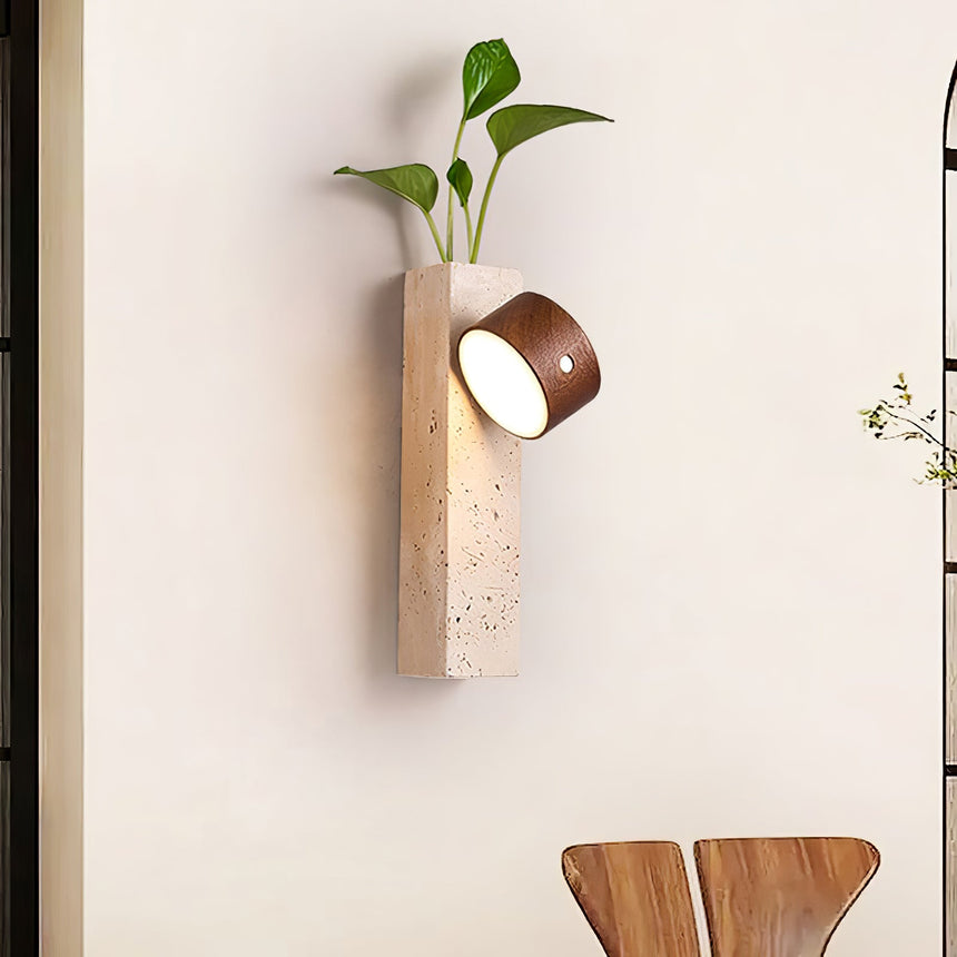 Wall sconce lit above a dining chair, the head turned toward the table