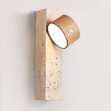 Light wood head tilted upward on a travertine backplate, seen close up