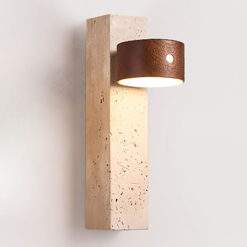 Travertine wall sconce with a dark walnut head, lit against a plain wall