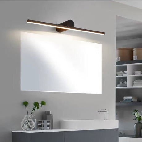 Black bar lit above a wide bathroom mirror over a stone basin with a vase