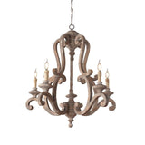 The old gray finish against a pale wall, five candle arms on the carved wood frame