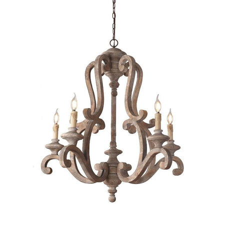 The old gray finish against a pale wall, five candle arms on the carved wood frame