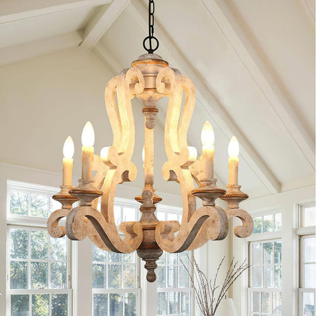 Lit under a white vaulted ceiling in front of tall windows above a table with a vase