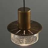 The fluted underside of the brass cap seen against a dark background