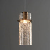 A tall clear crackle cylinder lit showing the brass holder inside it