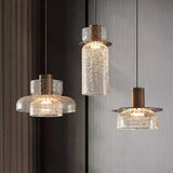 Three crackle glass shades of different heights lit on brass caps