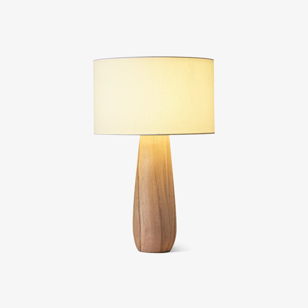 Cream table lamp with a linen drum on a light wood bottle base