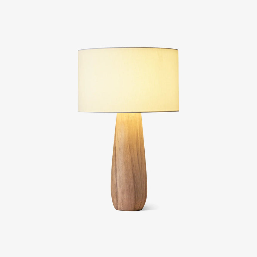 Cream table lamp with a linen drum on a light wood bottle base