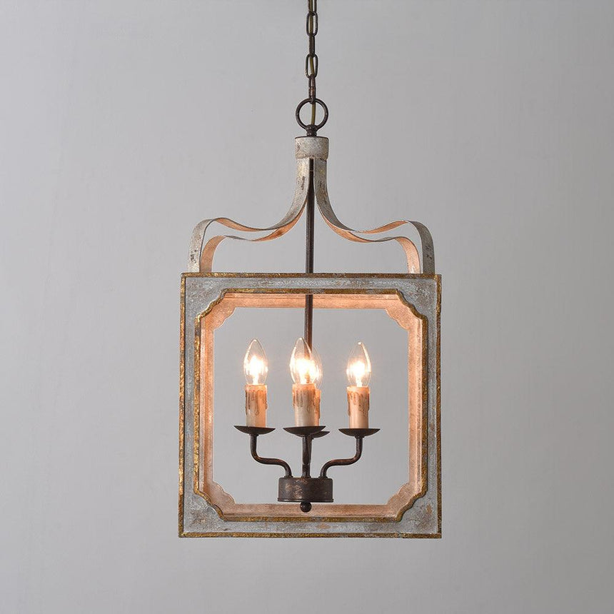 The cube frame lit against a pale wall, four candle lamps burning inside