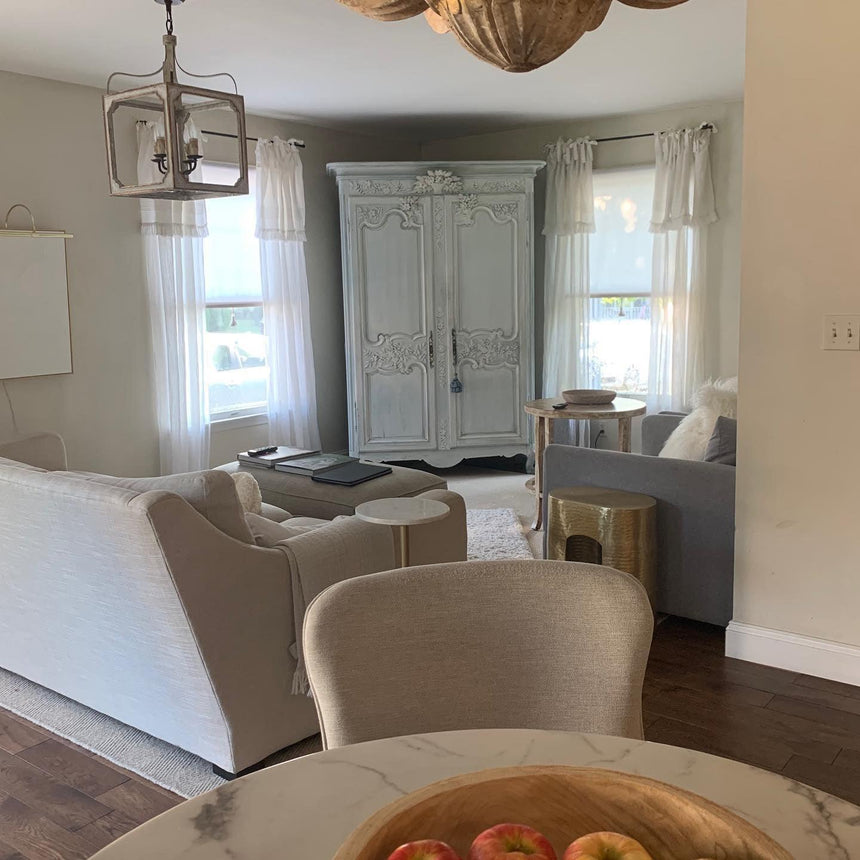 Lit in an open plan room with tall doors, seating and a fruit bowl below