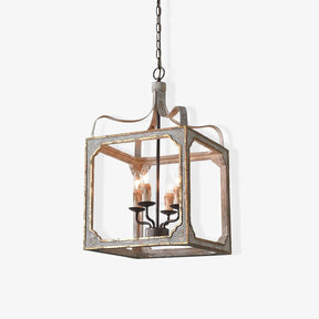 A washed wood cube frame with metal corners holding four candle lamps inside