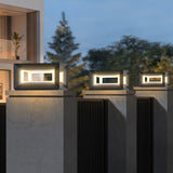 Cubes glowing on pillars with tall trees behind them after sunset