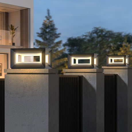 Cubes glowing on pillars with tall trees behind them after sunset