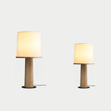 Two cylinder table lamps of different heights side by side