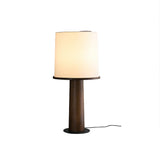 The walnut version of the cylinder table lamp, lit front view