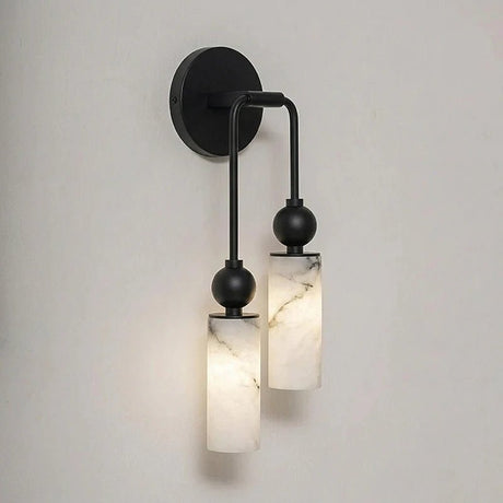 The black version with two lit stone cylinders on a plain wall