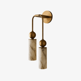 The brass version with two stone cylinders, seen on a white background