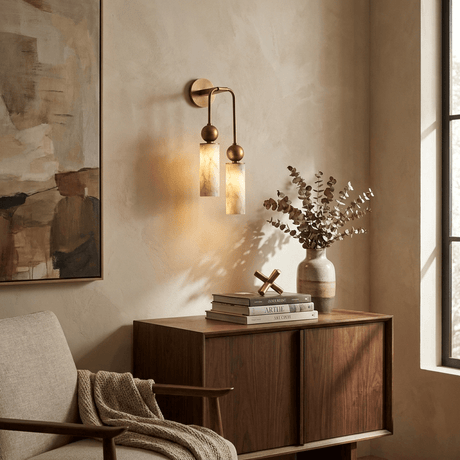 The light lit above a wood cabinet with books and a vase in a living room
