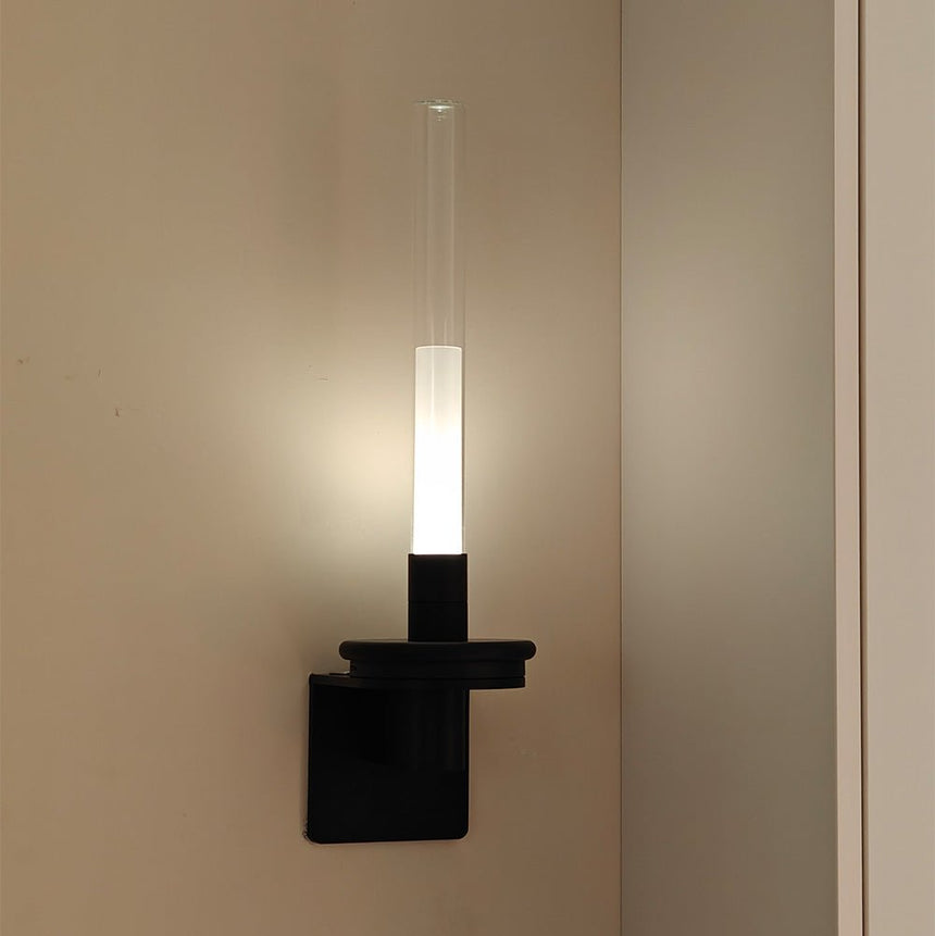 Lit in a warm corner beside a door frame, the stem glowing against the wall