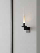 Lit on a fluted wall panel, the stem standing clear of the vertical grooves