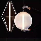 Close view of a lit sphere and a lit vertical bar against a dark background