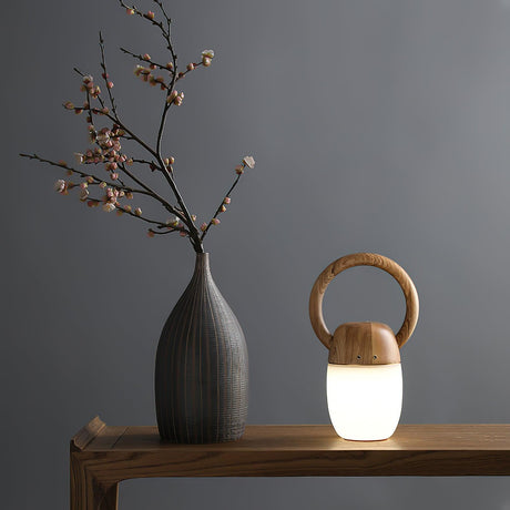 Dimmable bedside lamp lit on a wooden console beside a tall stone vase