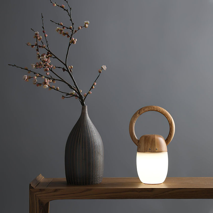 Dimmable bedside lamp lit on a wooden console beside a tall stone vase