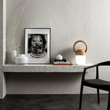 Dimmable bedside lamp lit on a plaster shelf beside a framed print
