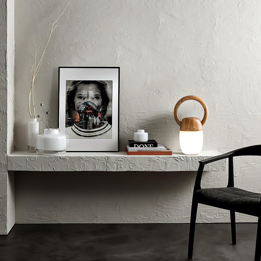 Dimmable bedside lamp lit on a plaster shelf beside a framed print