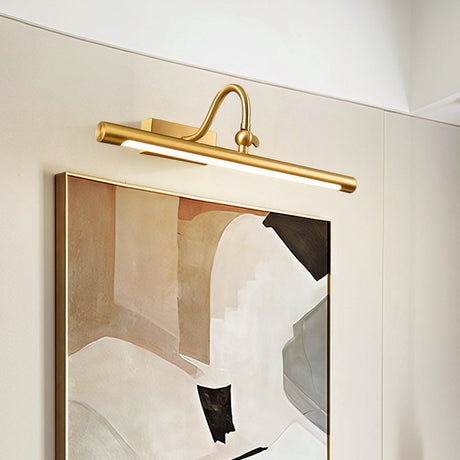 The curved arm version lit above a framed artwork on a pale wall