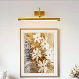 Brass bar lit above a framed floral canvas on a pale painted wall