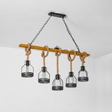 Chandelier lit beside a kitchen counter with bottles and stools